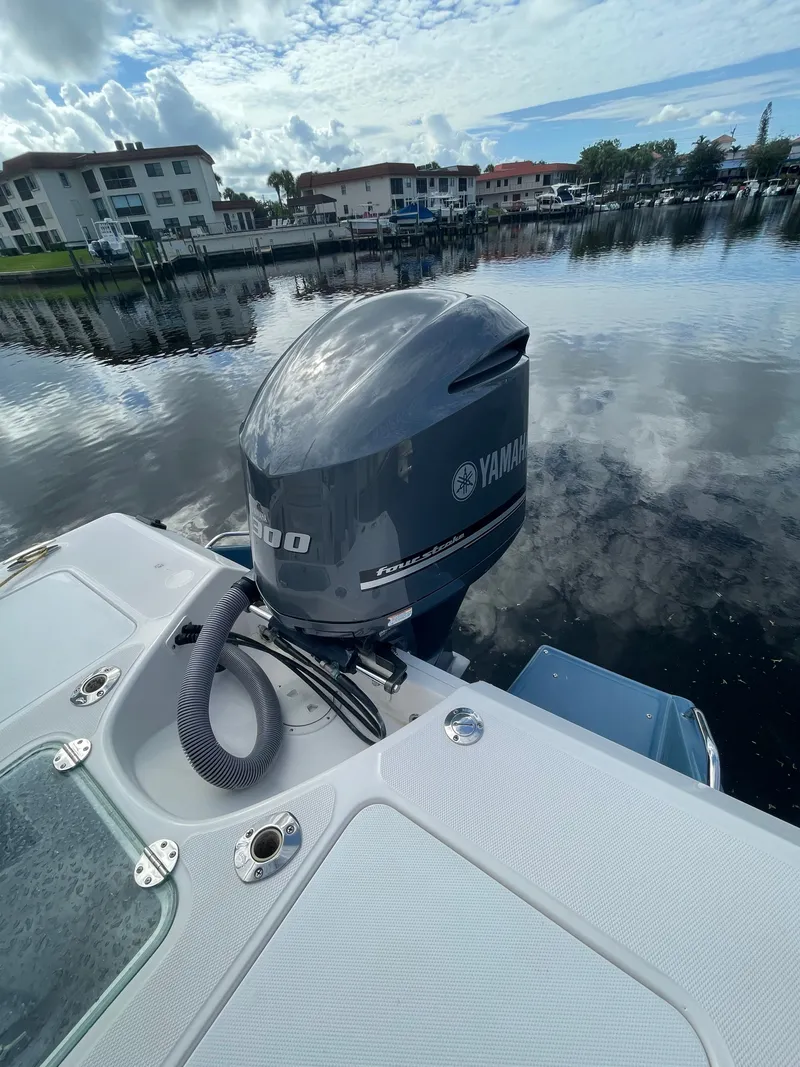 Slide: The Image of A 2012 Everglades 243 Center Console boat with a Yamaha outboard motor on calm water. - 12