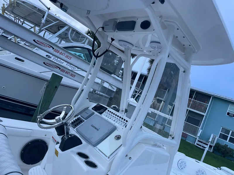 Slide: The Image of The image shows the helm of a 2012 Everglades 243 Center Console boat. - 14