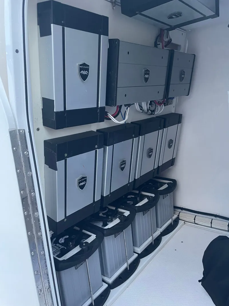 Slide: The Image of Batteries and electronics in a boat storage compartment, neatly arranged and wired. - 17