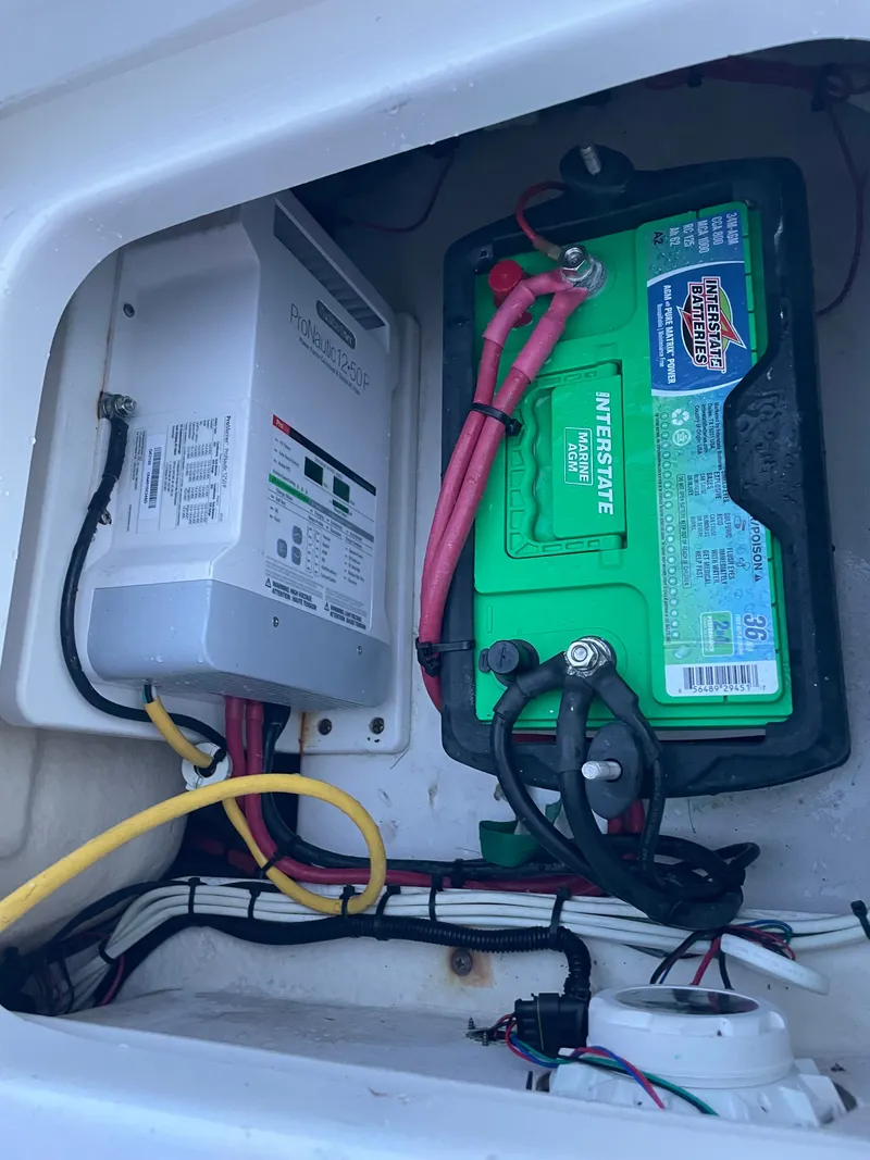 Slide: The Image of Battery and wiring inside a boat storage compartment. - 21
