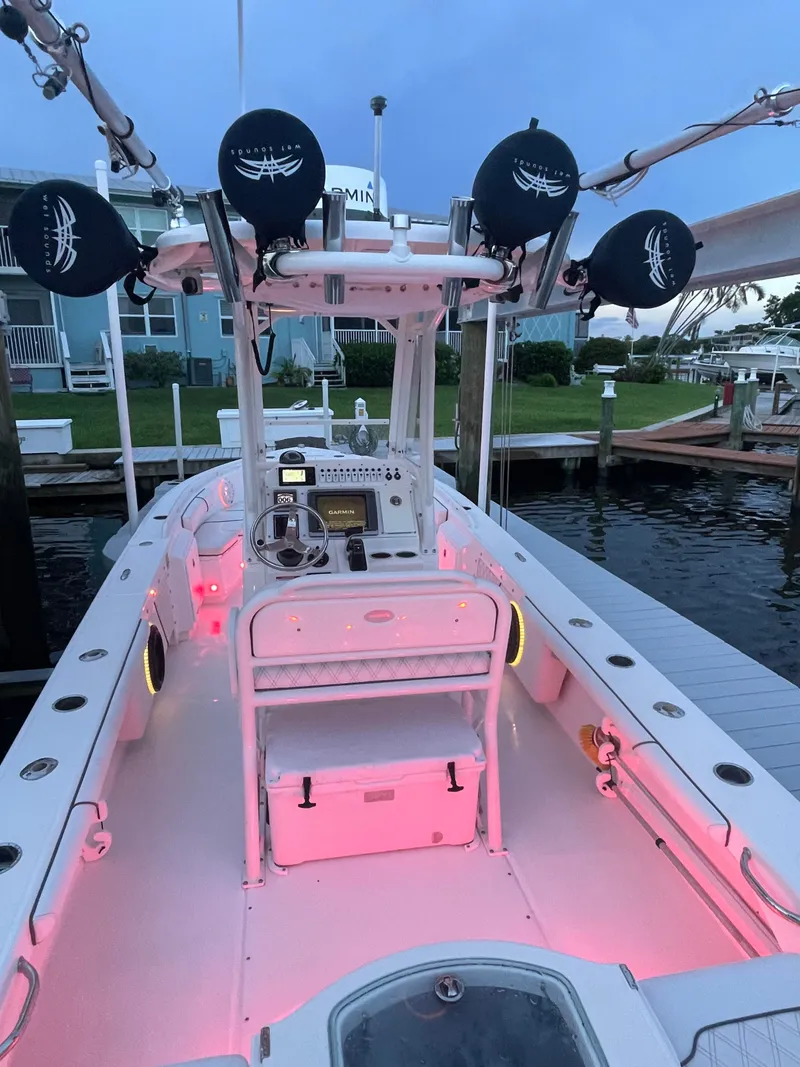 Slide: The Image of A 2012 Everglades 243 Center Console boat with pink lighting at the dock. - 22