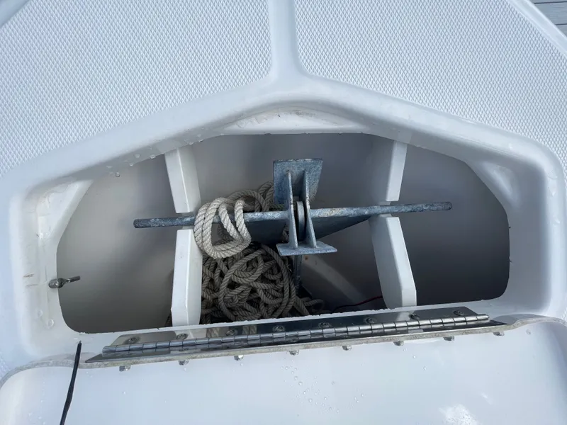 Slide: The Image of An anchor locker with an anchor and ropes on a boat. - 27
