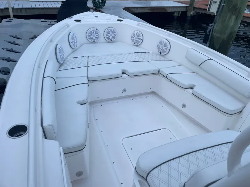 Slide: The Image of The image shows the cockpit of a 2012 Everglades 243 Center Console boat with white seating and speakers. - 28