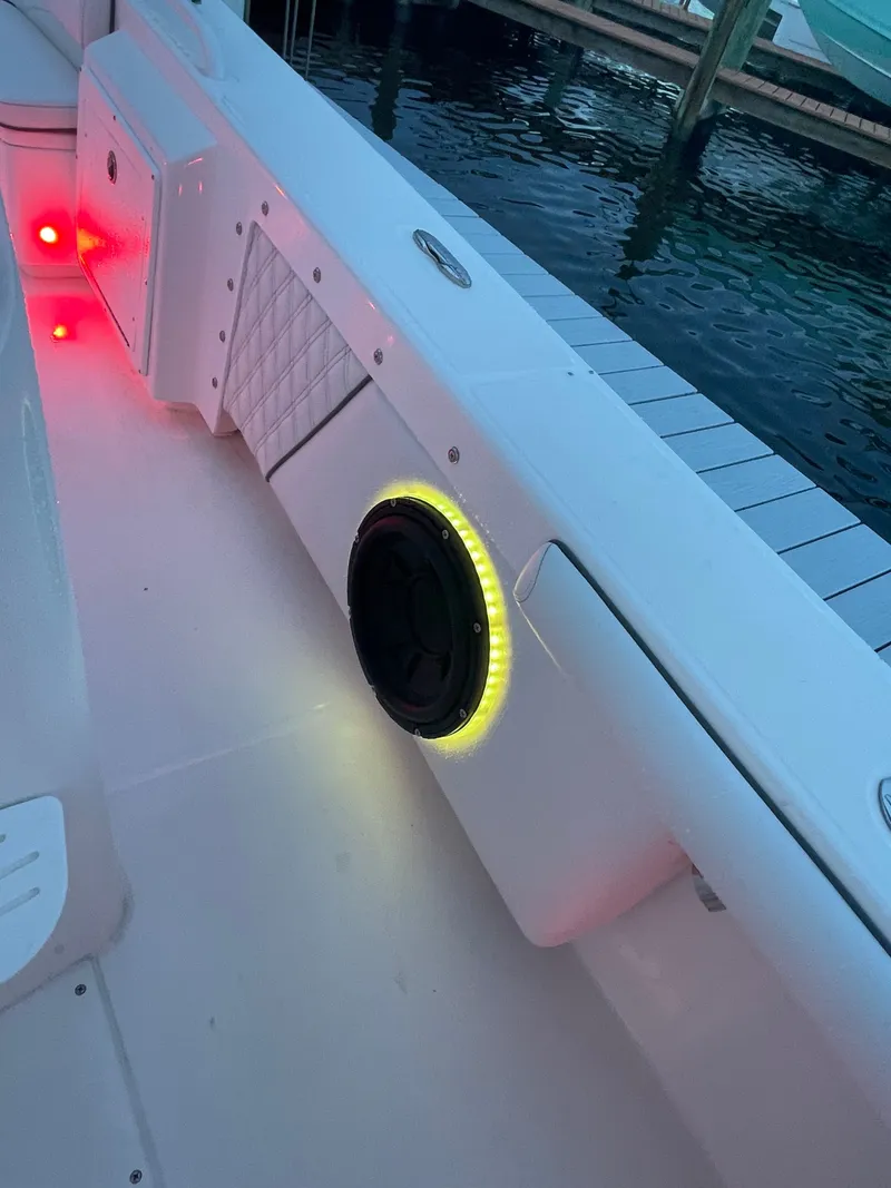 Slide: The Image of The image shows the interior of an Everglades 243 Center Console boat with a lit speaker. - 33