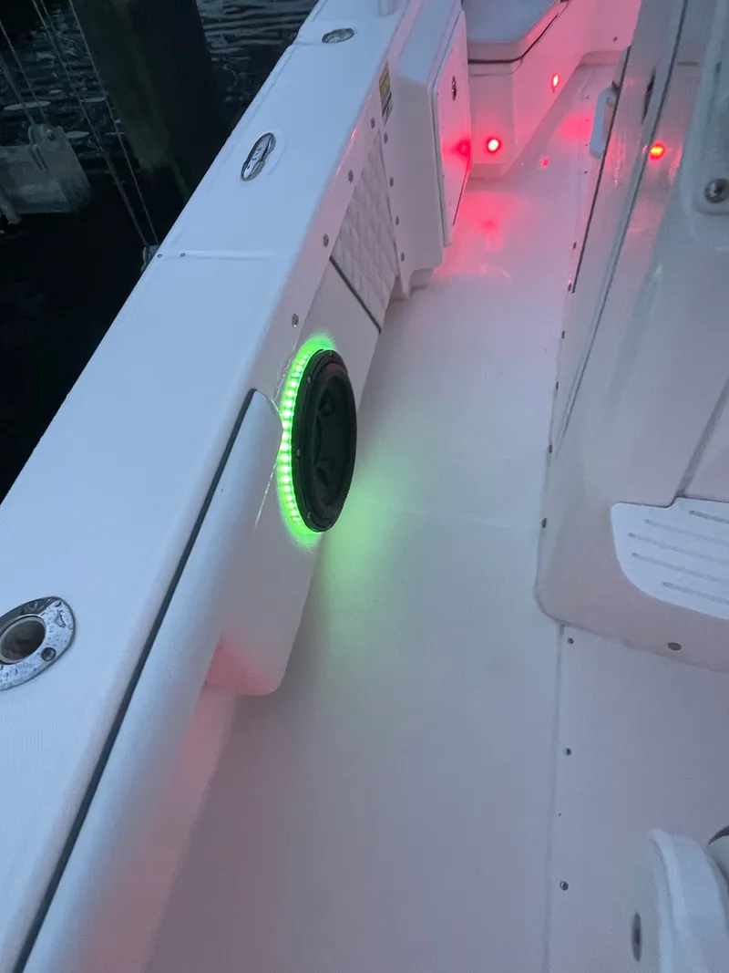 Slide: The Image of The image shows the deck of an Everglades 243 Center Console boat with colored lighting. - 34
