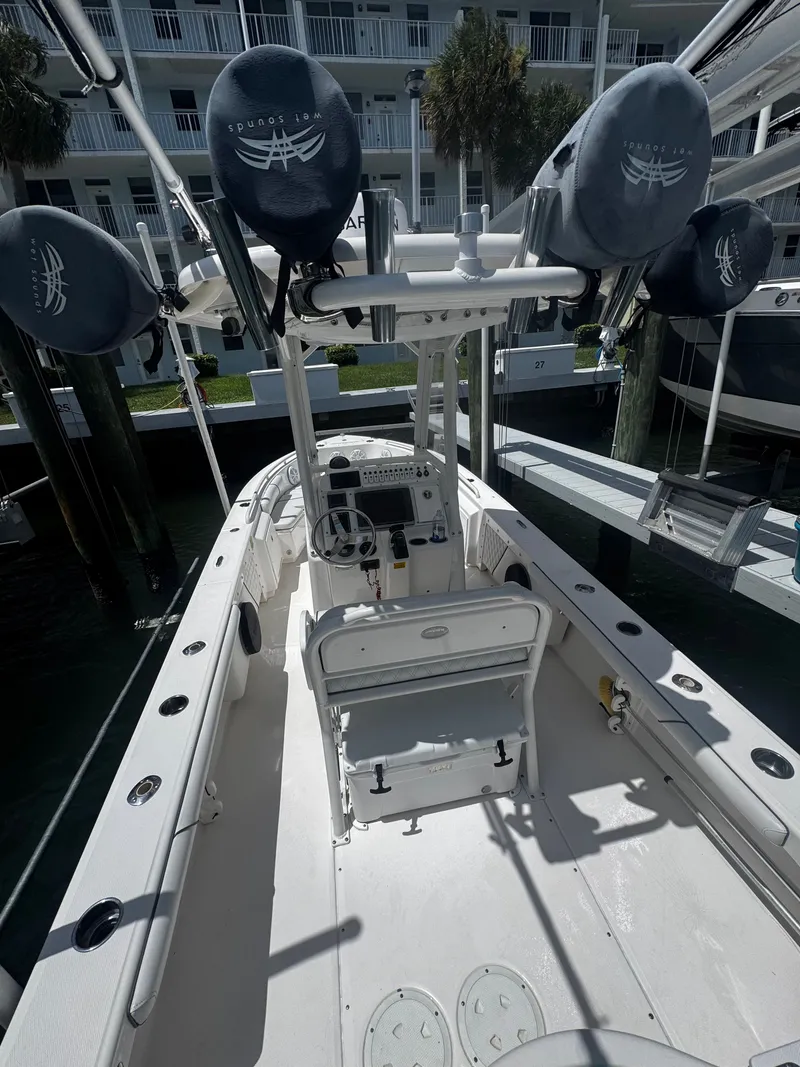 Slide: The Image of A 2012 Everglades 243 Center Console boat with a spacious deck and multiple fishing rod holders. - 9