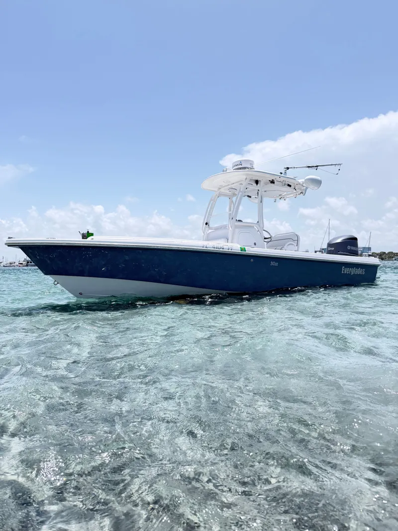 Slide: The Image of A 2012 Everglades 243 Center Console boat on clear water under a blue sky. - 5