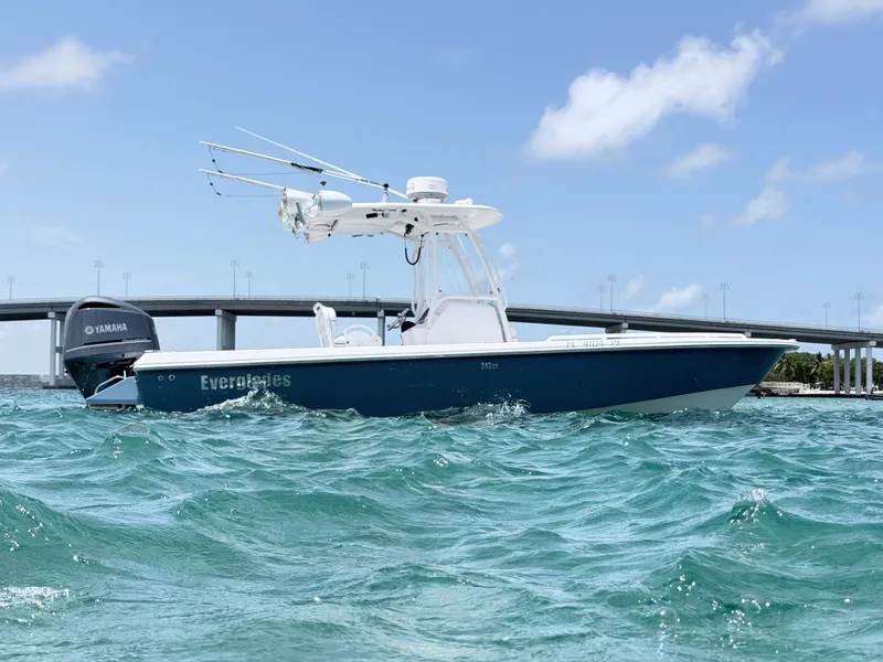 Slide: The Image of A 2012 Everglades 243 Center Console boat on the water, with a bridge in the background. - 1