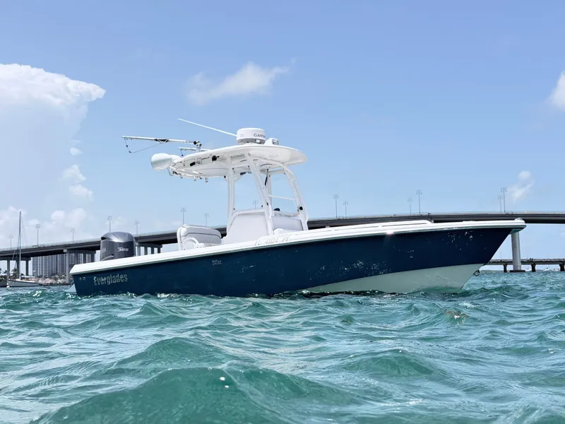 The Image of A 2012 Everglades 243 Center Console boat on the water near a bridge. - 0