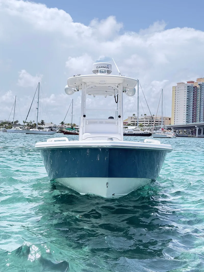 Slide: The Image of A 2012 Everglades 243 Center Console boat on calm water with a cityscape in the background. - 4