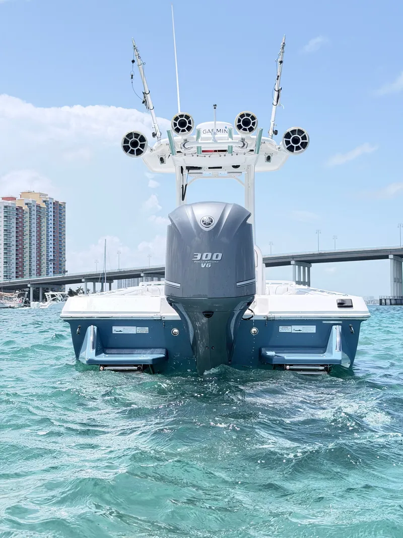 Slide: The Image of A 2012 Everglades 243 Center Console boat on the water, with a bridge in the background. - 3
