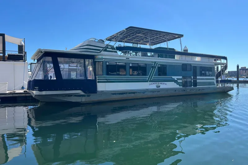 The Image of 1993 Sumerset houseboat docked on calm water under clear blue sky. - 1