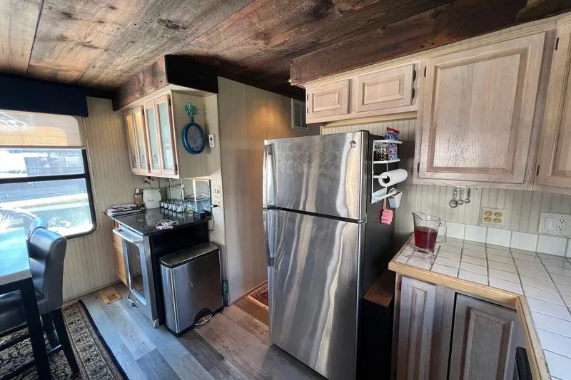 Slide: The Image of 1993 Sumerset houseboat kitchen with stainless steel appliances and wooden cabinetry. - 12