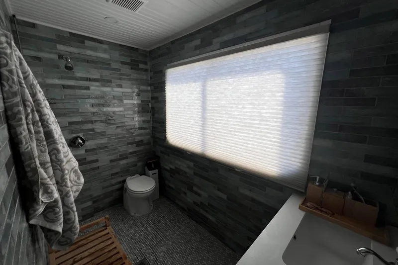 Slide: The Image of Bathroom interior of a 1993 Sumerset houseboat with modern gray tile design. - 17
