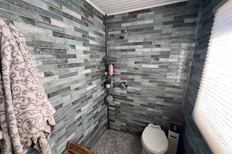 Slide: The Image of Bathroom interior of a 1993 Sumerset houseboat with modern tiled walls and fixtures. - 18