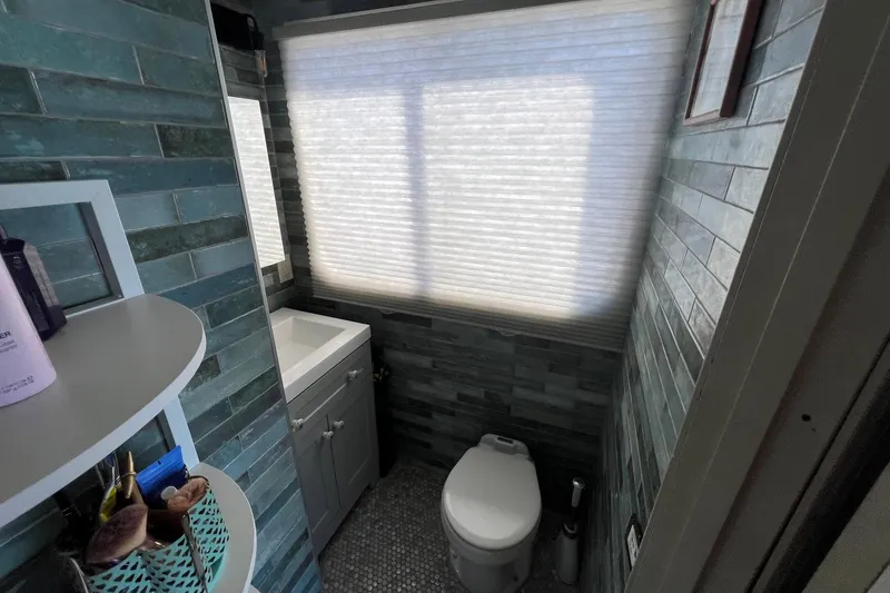 Slide: The Image of Bathroom interior of a 1993 Sumerset houseboat with teal tiles and modern fixtures. - 22