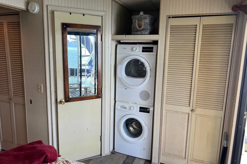 Slide: The Image of Laundry area inside a 1993 Sumerset houseboat with stacked washer and dryer. - 23