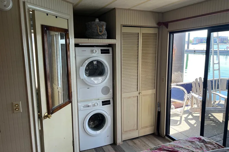 Slide: The Image of Interior of a 1993 Sumerset houseboat with stacked washer and dryer, near sliding glass door. - 24