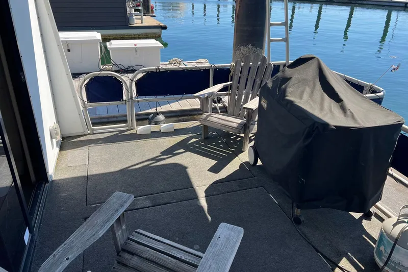 Slide: The Image of Deck of a 1993 Sumerset houseboat with chairs and a covered grill. - 27