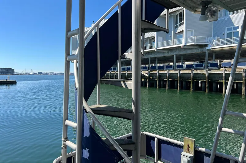 Slide: The Image of Spiral staircase on 1993 Sumerset houseboat docked by waterfront buildings. - 28