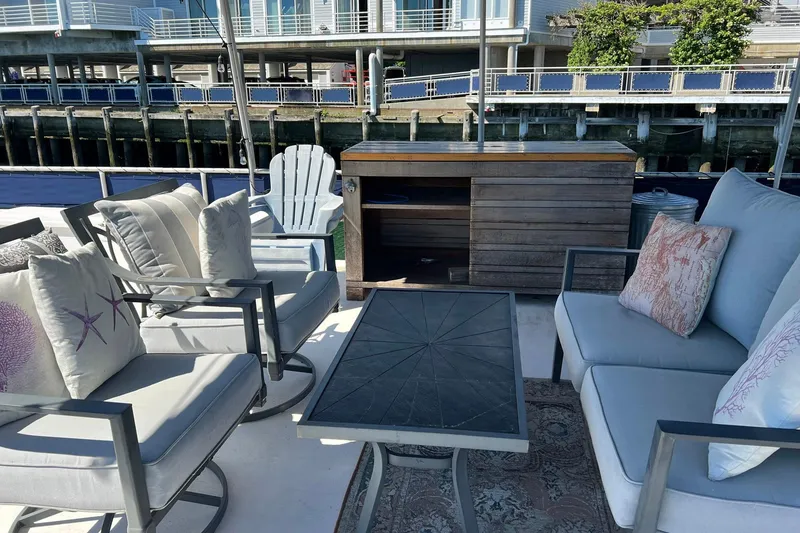 Slide: The Image of Cozy outdoor seating on a 1993 Sumerset houseboat with stylish cushions and a wooden cabinet. - 32