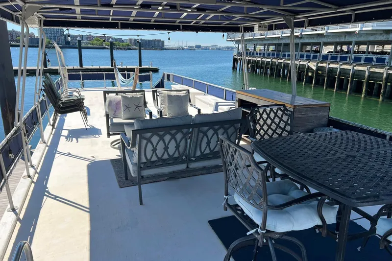 Slide: The Image of 1993 Sumerset houseboat deck with seating, table, and waterfront view. - 34