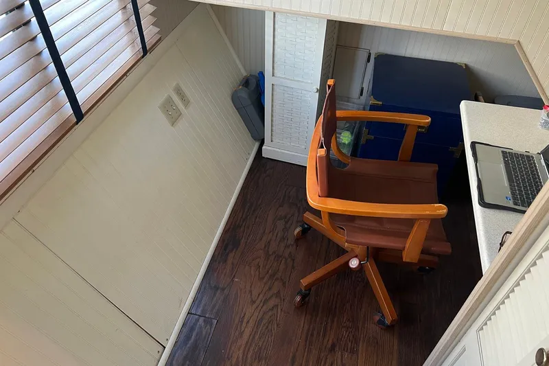 Slide: The Image of Cozy workspace on a 1993 Sumerset houseboat with wooden chair and laptop. - 37