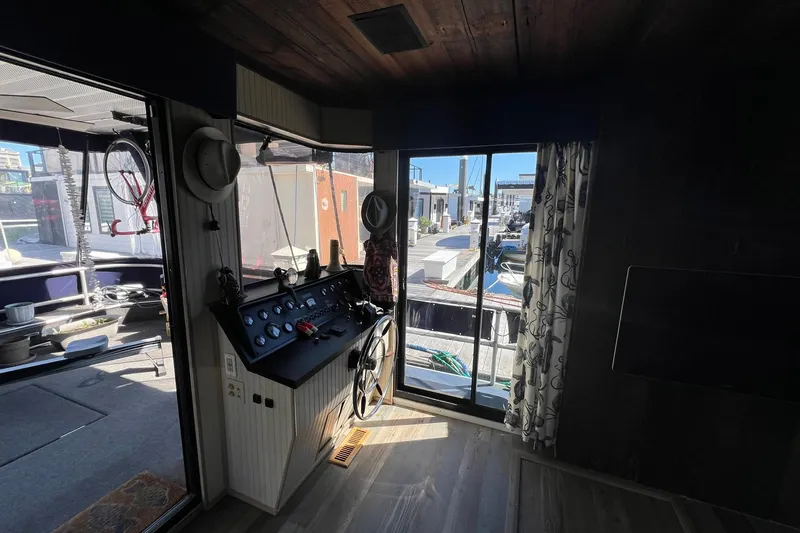 Slide: The Image of Interior view of a 1993 Sumerset houseboat with helm and marina view. - 6