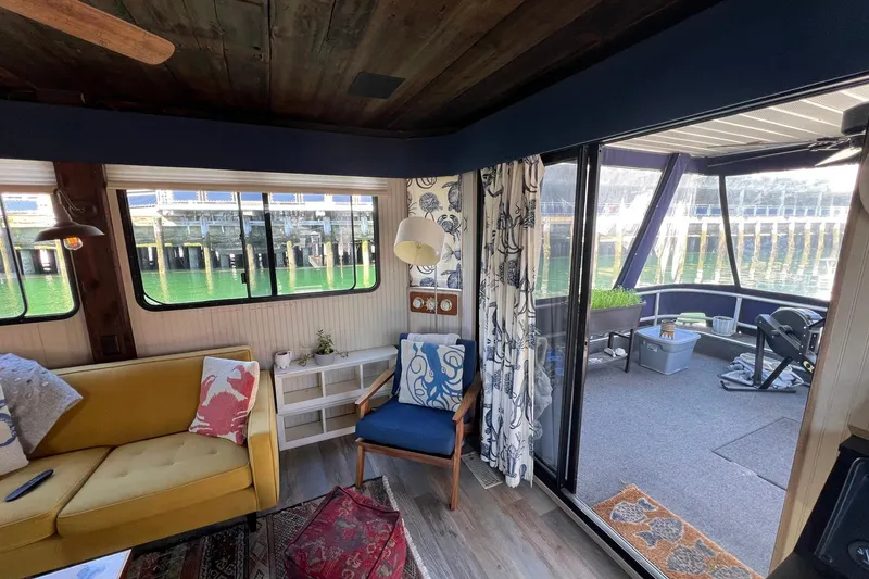 Slide: The Image of Interior of a 1993 Sumerset houseboat with cozy seating and waterfront view. - 7