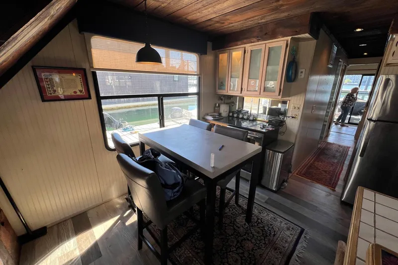 Slide: The Image of Interior of a 1993 Sumerset houseboat kitchen with dining area and window view. - 8