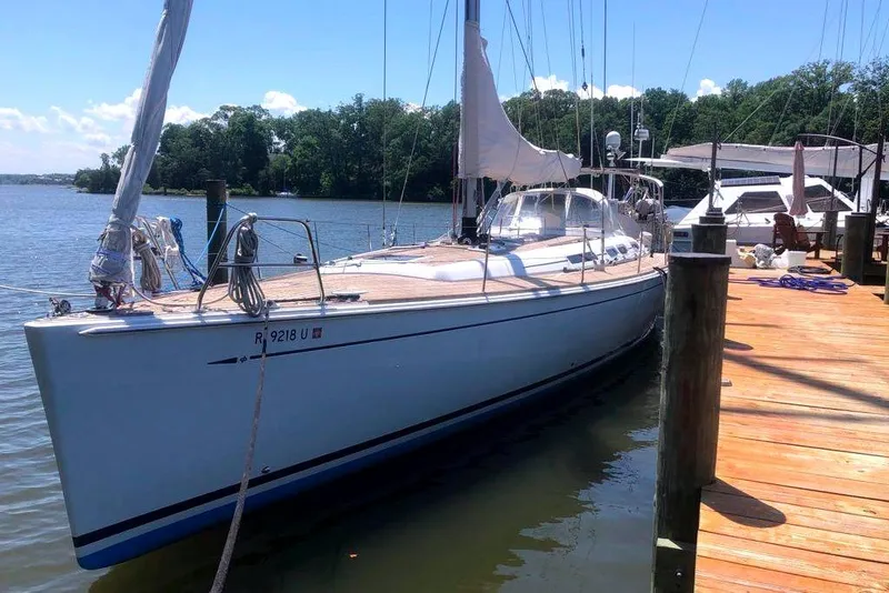 Slide: The Image of 2006 Grand Soleil 50 sailboat docked by a wooden pier on a sunny day. - 3