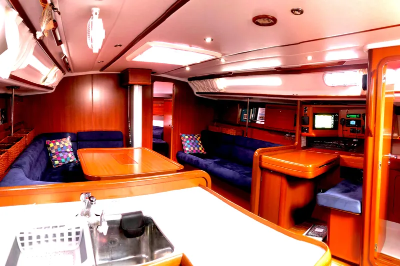 Slide: The Image of Luxurious interior of 2006 Grand Soleil 50 yacht with wood finish and blue seating. - 5