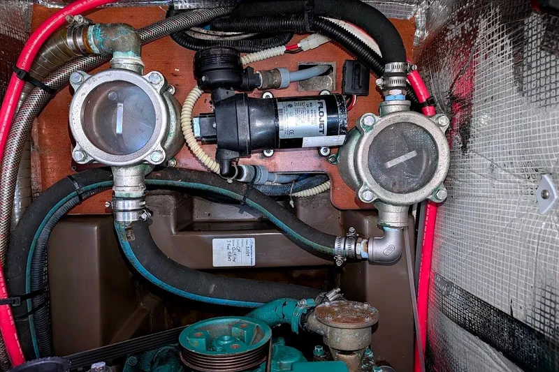 Slide: The Image of Engine compartment of a 2006 Grand Soleil 50 yacht, featuring pumps and hoses. - 13