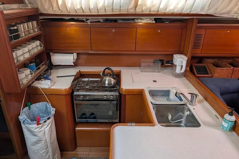Slide: The Image of Galley kitchen in 2006 Grand Soleil 50 yacht with stove, sink, and storage. - 17