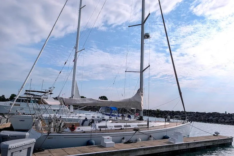 The Image of 2006 Grand Soleil 50 sailboat docked at a marina under a partly cloudy sky. - 2