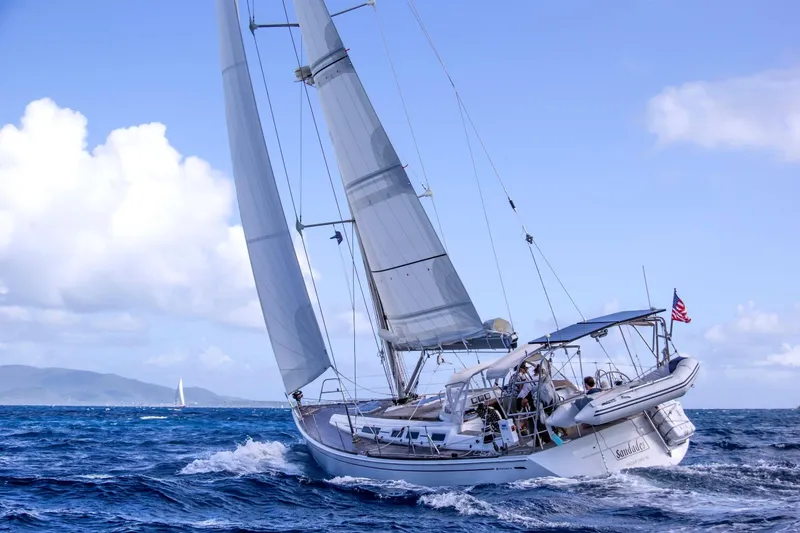 The Image of Sailing yacht Grand Soleil 50 (2006) navigating ocean waves under clear skies. - 1