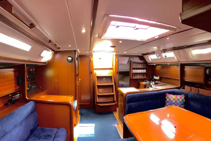 Slide: The Image of Luxurious interior of a 2006 Grand Soleil 50 yacht with wooden finishes and blue seating. - 7