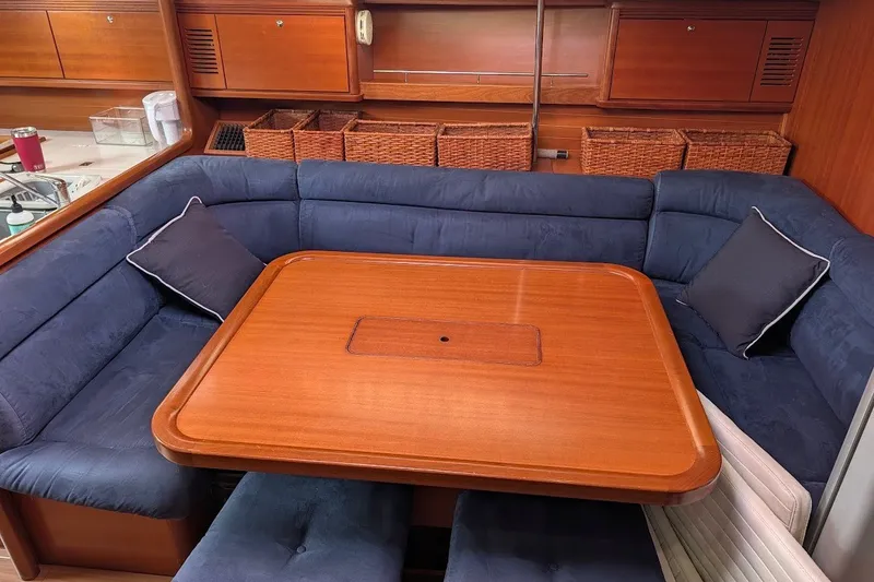 Slide: The Image of Luxurious interior of 2006 Grand Soleil 50 yacht with blue seating and wooden table. - 10