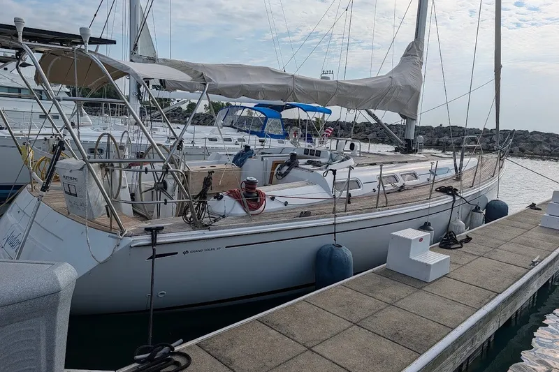Slide: The Image of Grand Soleil 50 sailboat from 2006 docked at a marina, featuring sleek design and spacious deck. - 3