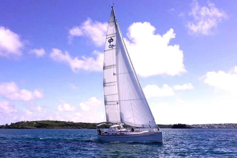 Slide: The Image of Sailing yacht Grand Soleil 50, 2006 model, gliding on blue waters under a clear sky. - 2