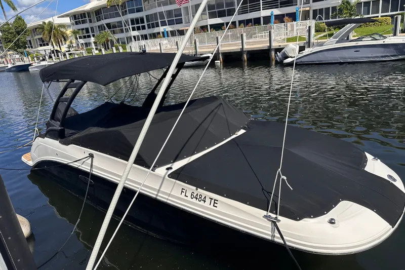 Slide: The Image of 2022 Sea Ray SDX 250 Outboard boat docked with black cover in marina. - 52
