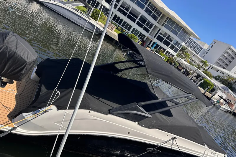 Slide: The Image of 2022 Sea Ray SDX 250 Outboard boat docked near waterfront buildings. - 53