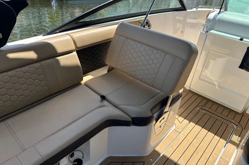 Slide: The Image of Luxurious seating on 2022 Sea Ray SLX 250 boat with elegant upholstery and teak flooring. - 25