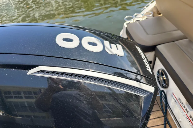 Slide: The Image of 2022 Sea Ray SLX 250 boat with Mercury 300 engine, docked by the water. - 47