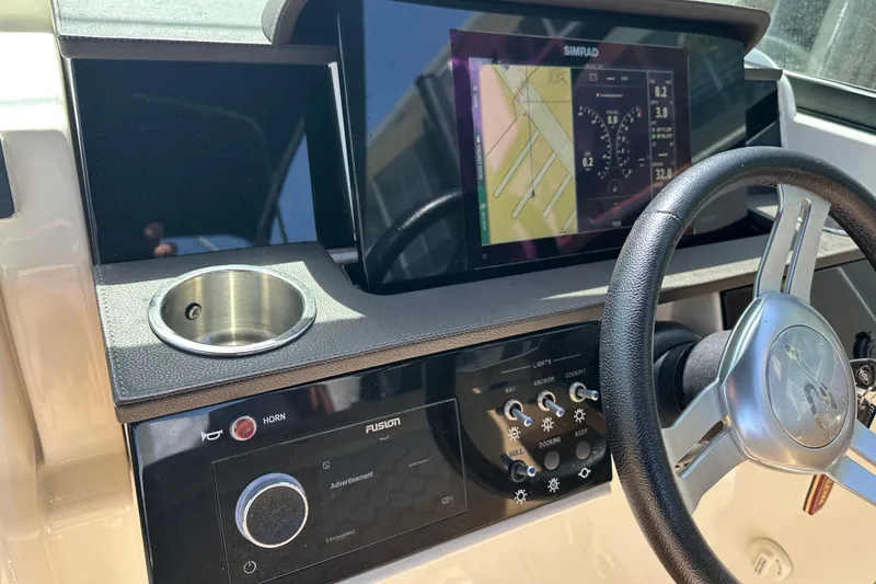 Slide: The Image of 2022 Sea Ray SLX 250 dashboard with steering wheel and navigation display. - 19