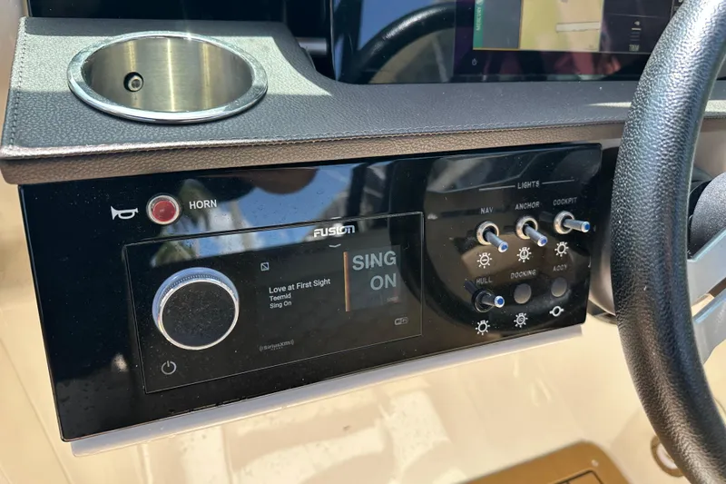 Slide: The Image of Control panel of 2022 Sea Ray SLX 250 boat with audio and light switches. - 16