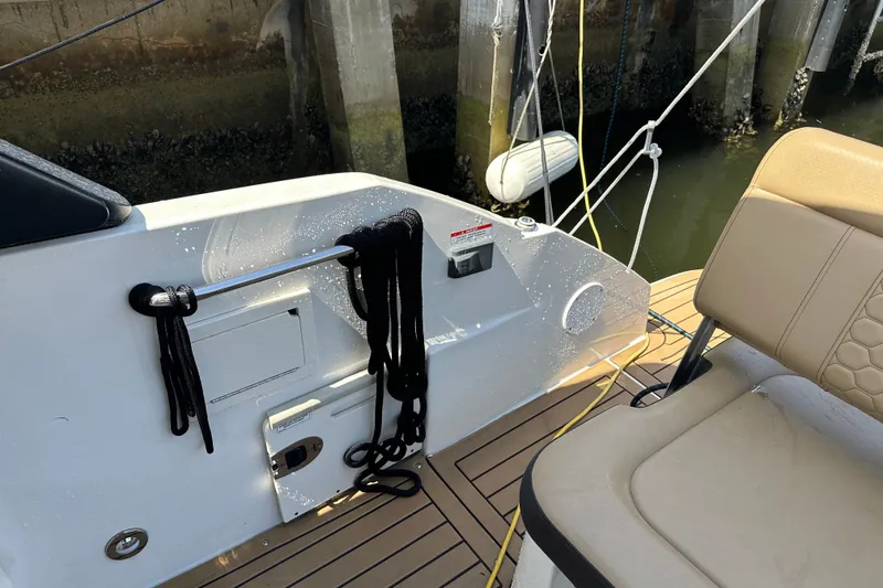 Slide: The Image of 2022 Sea Ray SLX 250 boat deck with seating and mooring ropes. - 35