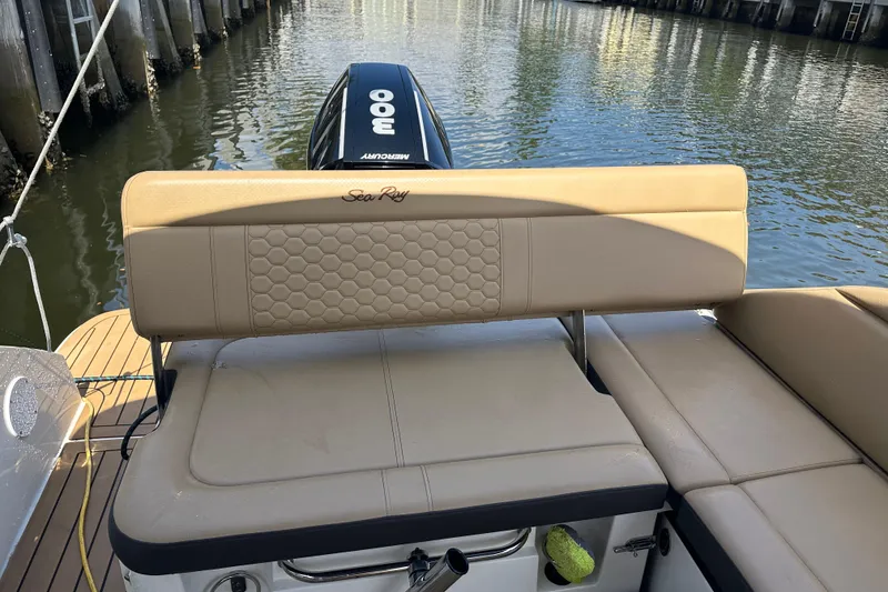 Slide: The Image of 2022 Sea Ray SLX 250 boat with tan seating and Mercury 300 engine on calm water. - 26