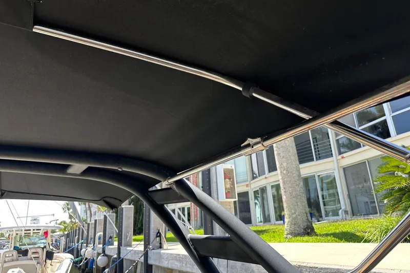 Slide: The Image of 2022 Sea Ray SLX 250 boat canopy and frame detail at dockside. - 33