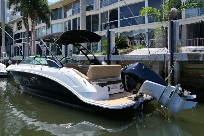 Slide: The Image of 2022 Sea Ray SLX 250 boat docked by waterfront building. - 3